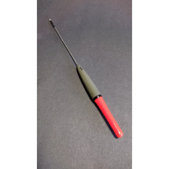 Handmade grayling fishing float with balsa body and stainless steel wire stem on black background