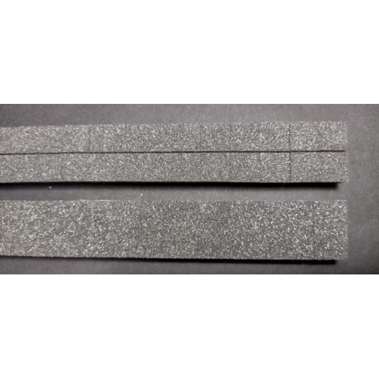 Two slim slotted float foam strips above one wide slotted float foam strips for size comparison