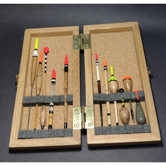 Traditional fishing floats neatly held in foam strip inside tackle box