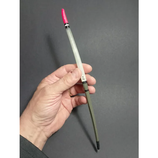 Handmade swan quill fishing float held in hand to show its length, size and scale.