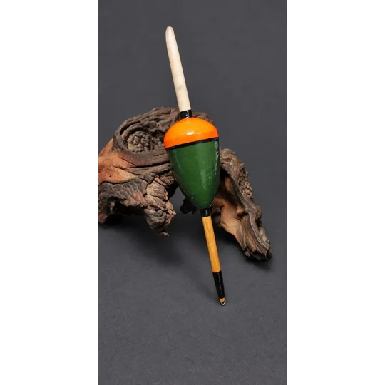 replica cork and quill pike float displayed next to driftwood