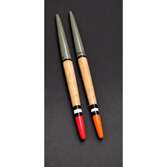 two replica balsa zeplin fishing floats on black paper