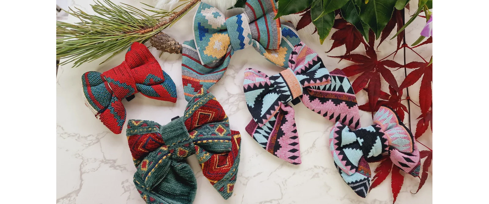 Patterned sailor bow ties for dogs on a marble surface