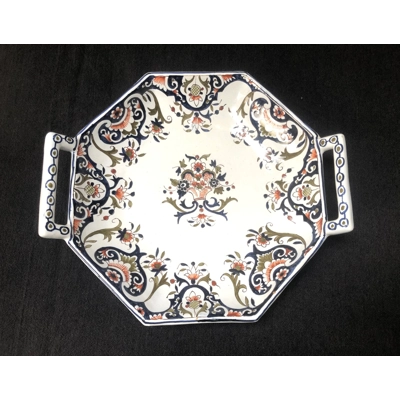 A hand painted ceramic dish with two handles