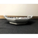 A hand painted ceramic dish with two handles