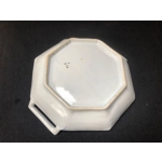 A hand painted ceramic dish with two handles