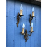 A trio of fine old French wall sconces lamps in a mix of brass/cast bronze in a rococo style: one two-lamp and two single-lamp wall sconces