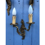 A trio of fine old French wall sconces lamps in a mix of brass/cast bronze in a rococo style: one two-lamp and two single-lamp wall sconces