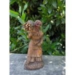 Folk art figurine of an old smiling country girl carrying a bundle of sticks armed with an axe ironware with great detail