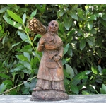Folk art figurine of an old smiling country girl carrying a bundle of sticks armed with an axe ironware with great detail