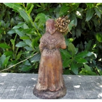 Folk art figurine of an old smiling country girl carrying a bundle of sticks armed with an axe ironware with great detail