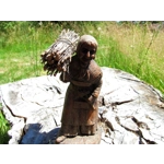 Folk art figurine of an old smiling country girl carrying a bundle of sticks armed with an axe ironware with great detail