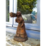 Folk art figurine of an old smiling country girl carrying a bundle of sticks armed with an axe ironware with great detail