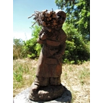 Folk art figurine of an old smiling country girl carrying a bundle of sticks armed with an axe ironware with great detail
