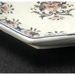 A hand painted ceramic dish with two handles