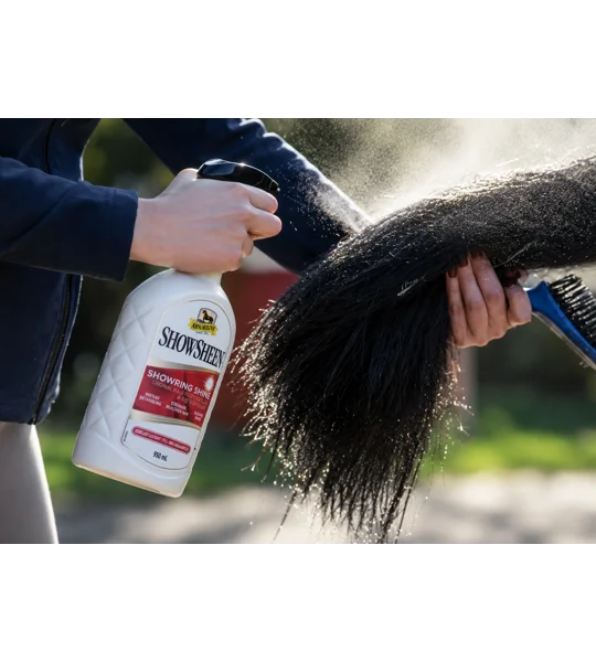 Spraying a horse coat with Absorbine ShowSheen Hair Polish to repel dust