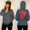"JUS' DEH YA." (red ink) zip hoodie