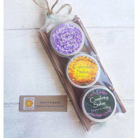 3 pots of calendula, comfrey and lavender balms in a set with cardboard backing and degradable plastic covering. A herbal kit