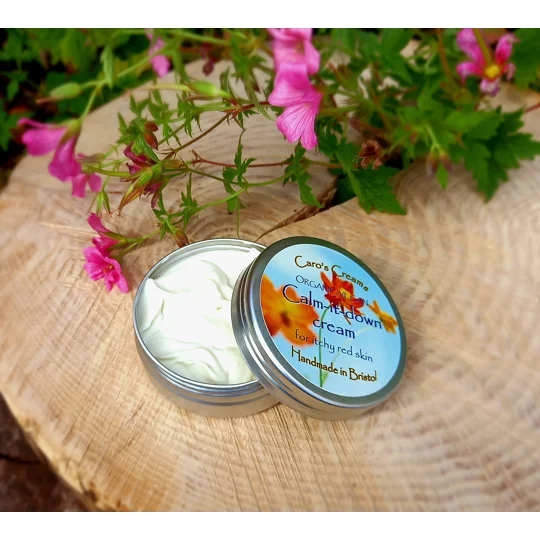 A silver tin of 60g Caro's Creams Calm-it-down cream for itchy red skin. The tin is open and the cream is visible. The tin is handmade in Bristol with chickweed infused oil, and calming ingredients - can help eczema prone skin.