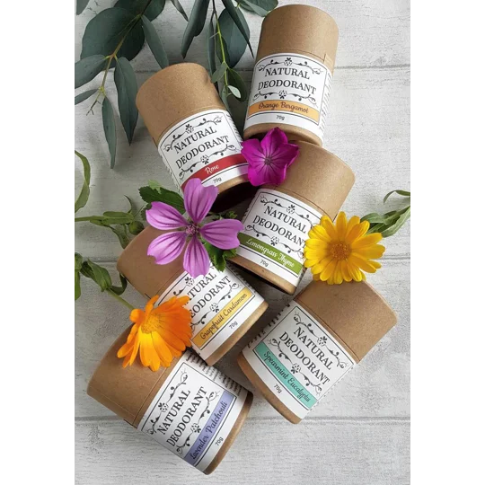 shows 6 scents of natural deodorant, in brown kraft push up tubes. Each scent is a different colour: lavender patchouli, spearmint eucalyptus, Grapefruit Cardamom, Lemongrass thyme, Rose and Orange Bergamot.