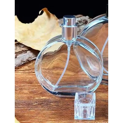 50ml Empty Glass Perfume Spray Bottles Round Clear Gold or Silver Screw off Pump title=