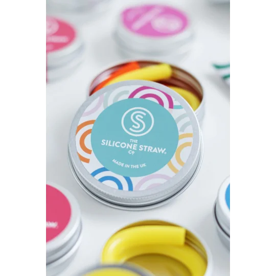an image of the colorful and playful branding on the top of the travel tins