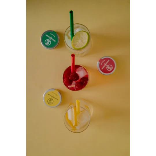 Reusable silicone straws in vibrant colours paired with a small travel Tins and drinks