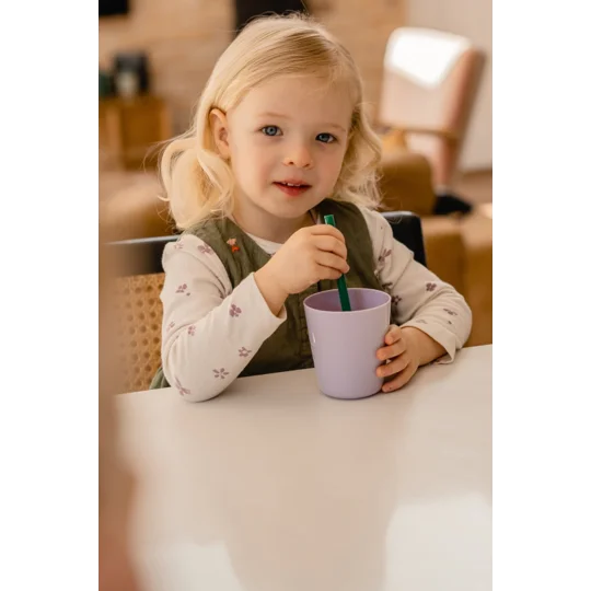 A child drinking with a reusable straw