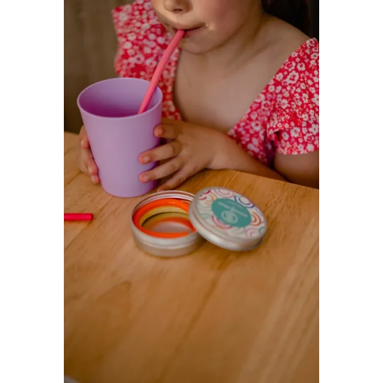 Child using a reusable silicone straw in a milkshake
