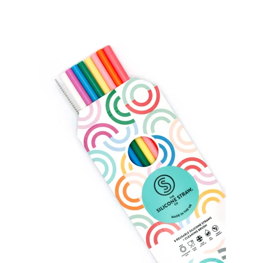 A range of colourful reusable straws coming out of their packaging