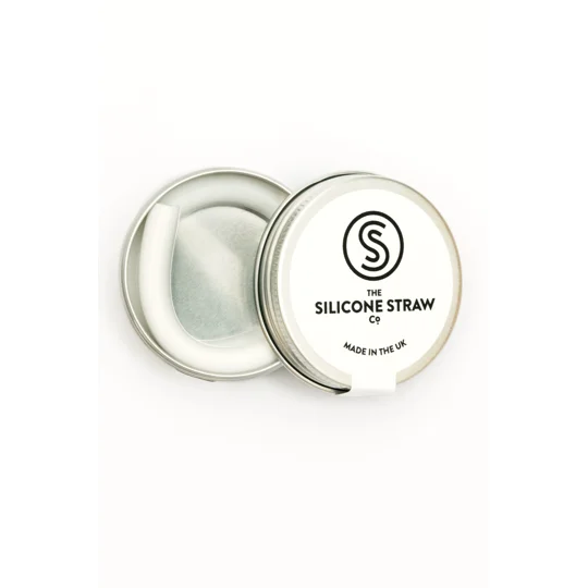 A white reusable straw in a tin
