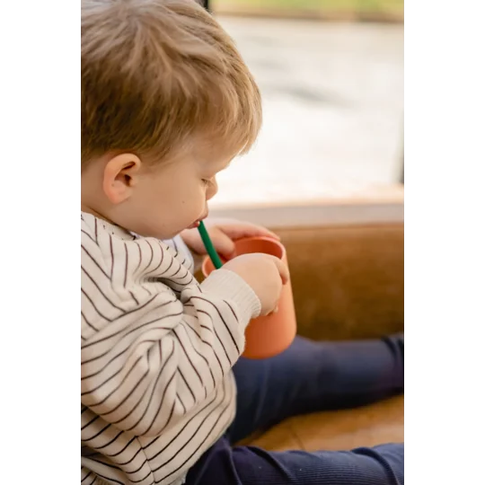 s mall boy using a straw to drink