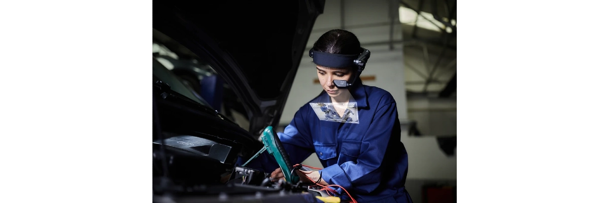 A photo of an automotive engineer at work and wearing a realwear headset