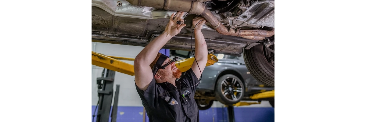 A photo of an automotive engineer at work and wearing a realwear headset