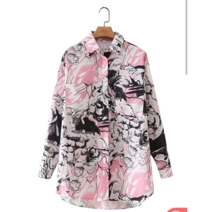 Gorgeous floral print long sleeve button down shirt with two patched pockets.