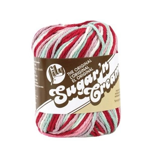Ball of thick cotton yarn in variegated colours of red, pink, aqua and white.