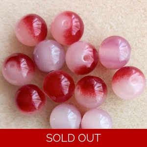 12, 12mm round glass beads, two tone red and white.