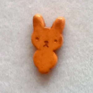 Dyed howlite rabbit bead, orange, 25mm x 12mm