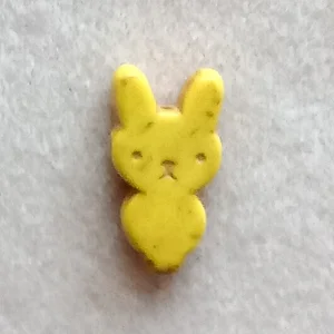 Dyed howlite rabbit bead, yellow, 25mm x 12mm