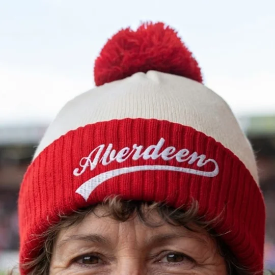 Close-up of the embroidered detail on an Aberdeen-inspired football bobble hat made from soft-feel acrylic