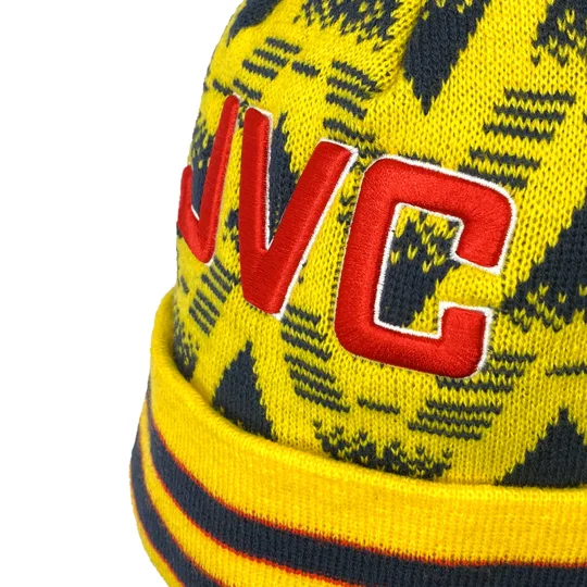Close-up of the front embroidery on an Arsenal-inspired vintage-style yellow bobble hat