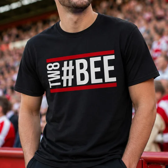 Bee Hashtag Fan T-Shirt — Black 100% cotton football fan T-shirt featuring bold white “#BEE” lettering with vertical “TW8” text and red horizontal stripes across the chest.