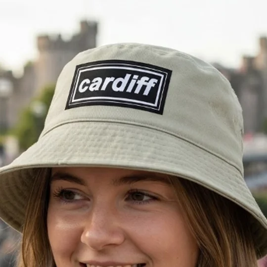 Sand cotton twill bucket hat featuring Cardiff-inspired retro 90s design and wide brim