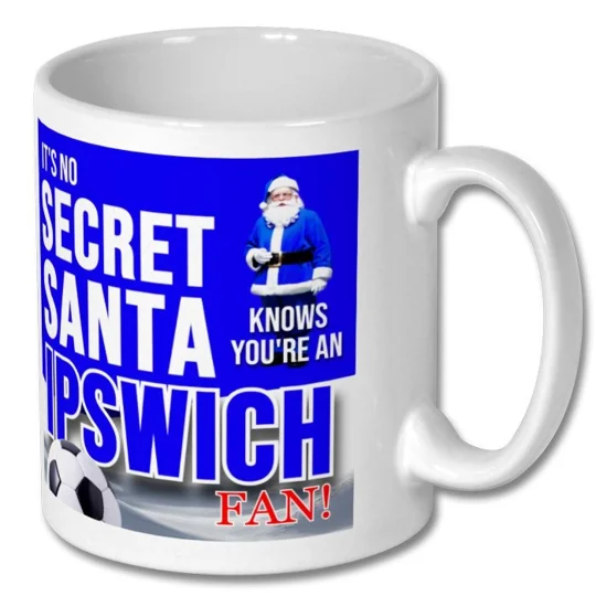 Close-up of the Ipswich-inspired football artwork on a white ceramic Christmas mug
