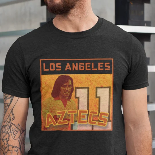 Black George Best Los Angeles Aztecs-inspired T-shirt featuring a full-colour retro football tribute design.