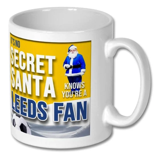 Close-up of the Leeds-inspired football artwork on a white ceramic Christmas mug