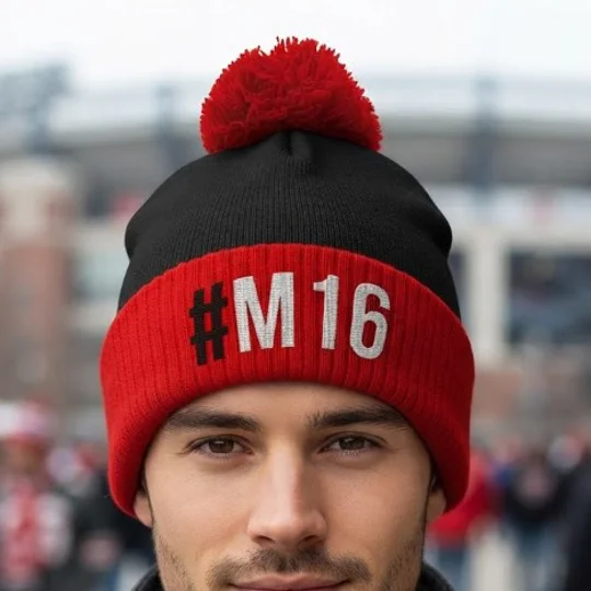 Close-up of Manchester M16-inspired football bobble hat showing embroidered detail and soft knit texture