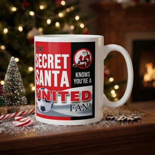 Man United-inspired Secret Santa Christmas gift mug with colourful football artwork on a white mug