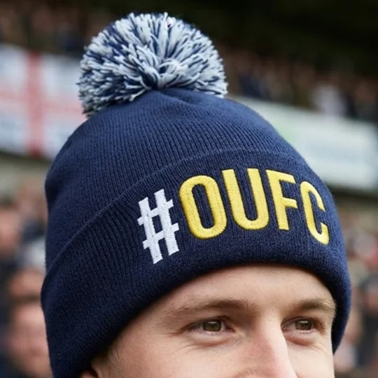 Oxford-inspired football bobble hat with embroidered hashtag design