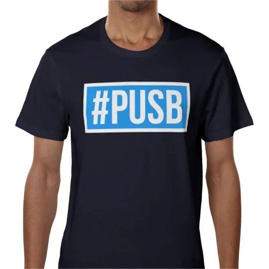 Model wearing the PUSB Coventry football T-shirt with bold hashtag graphic on the front